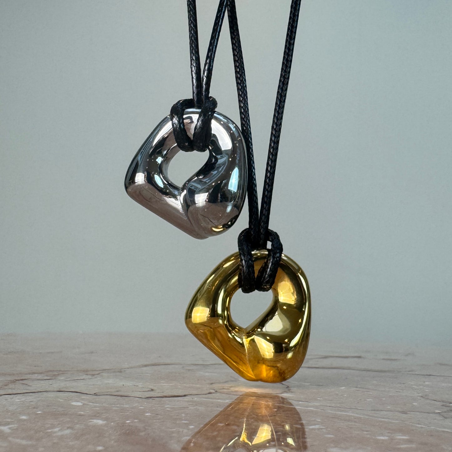 Adjustable molten irregular nugget pendants on black cord