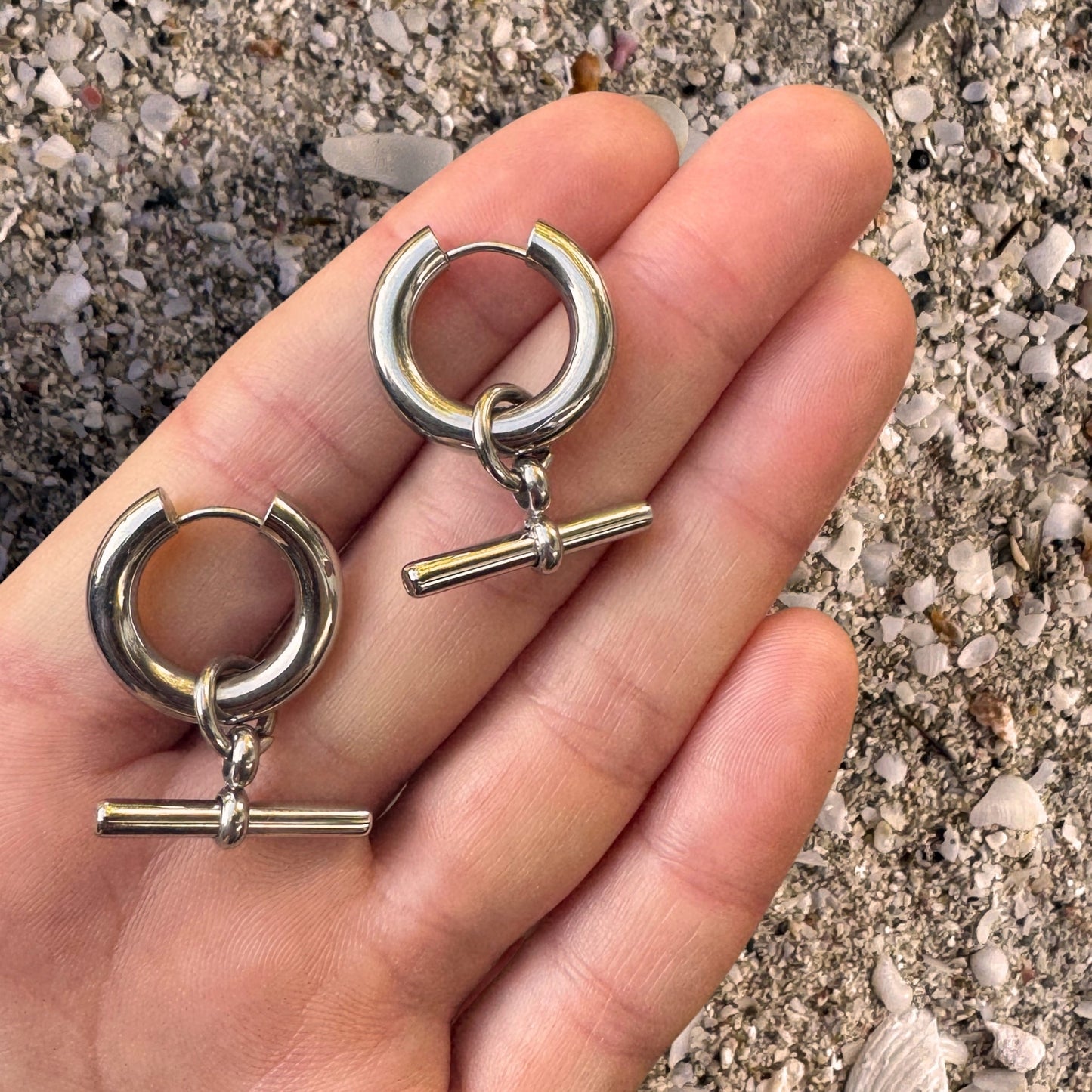 Silver T-bar Hoop Huggie Earrings in hand