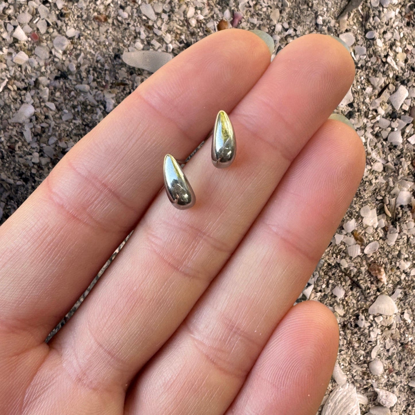 Silver Delicate Teardrop Studs in hand