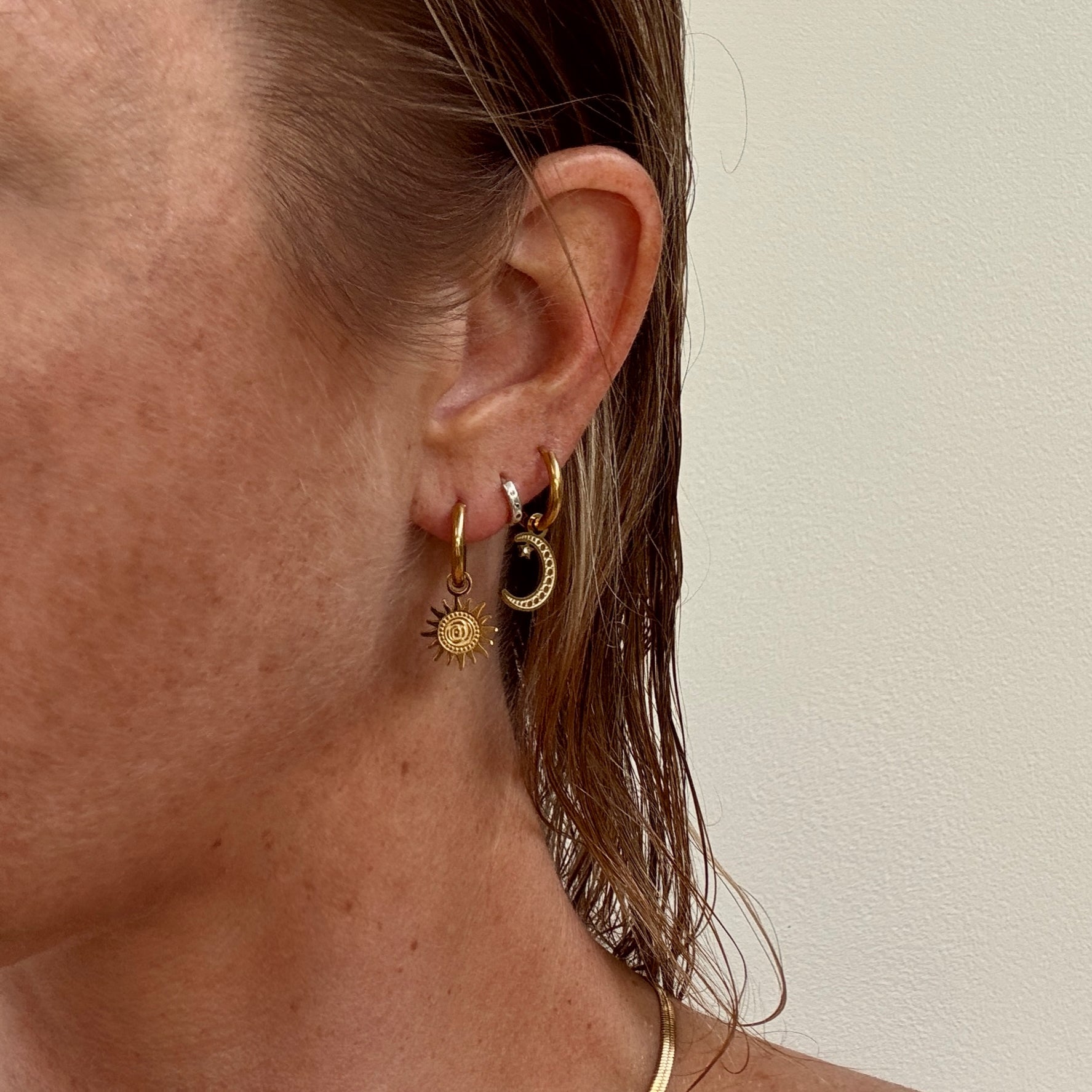 Gold plated sun and moon mismatched huggie hoop earrings from Jessica Rose jewellery