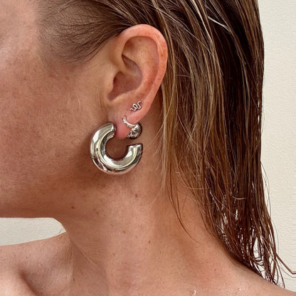 Silver chunky ball stud earrings from Jessica Rose jewellery worn on ear