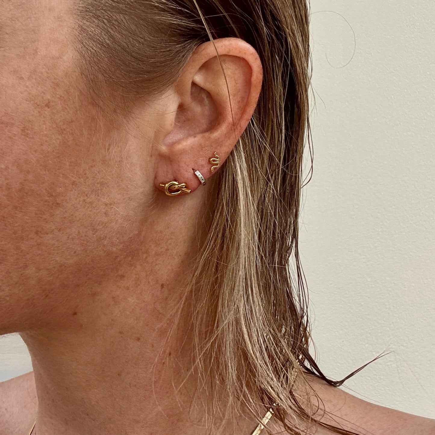 Gold Plated Knot Studs from Jessica Rose Jewellery on ear