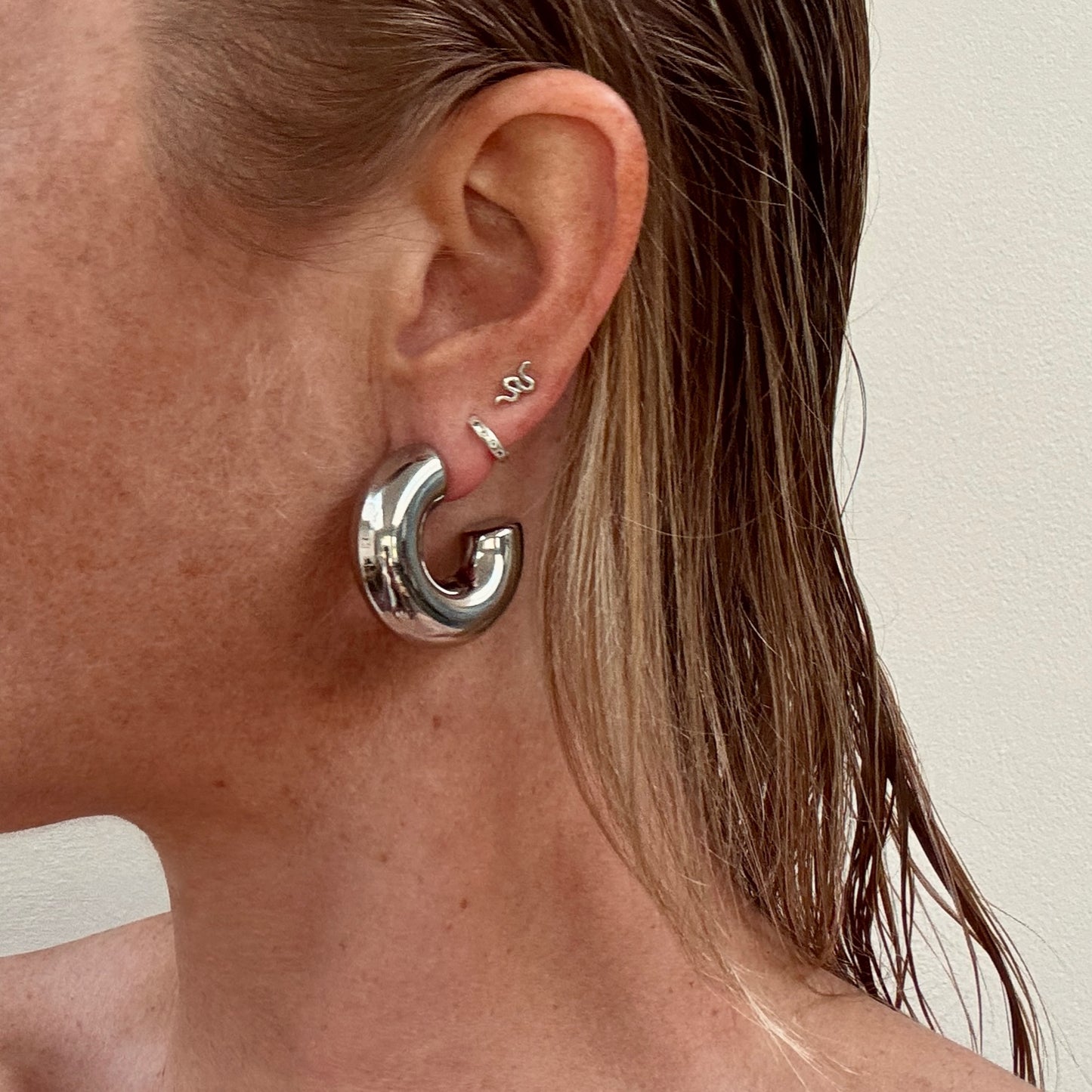 Large chunky silver C-shape hoop earrings from Jessica Rose jewellery