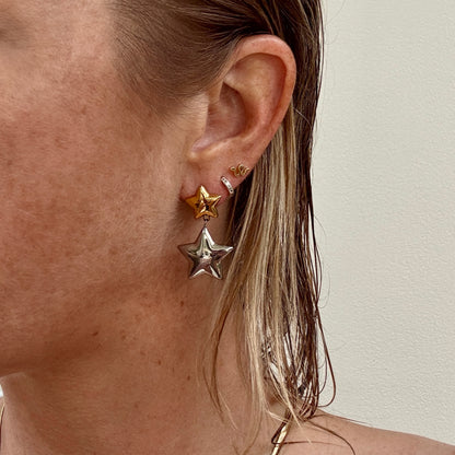 Double Star Dangly Earrings in Silver and Gold worn on ear
