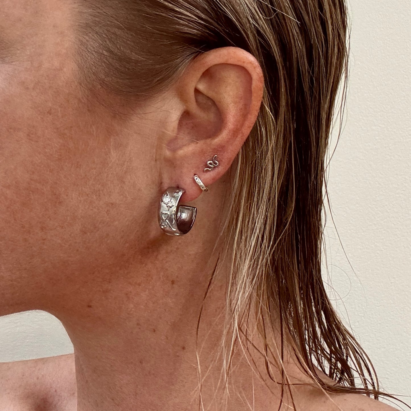 Silver tarot style earrings worn on ear by Jessica Rose jewellery