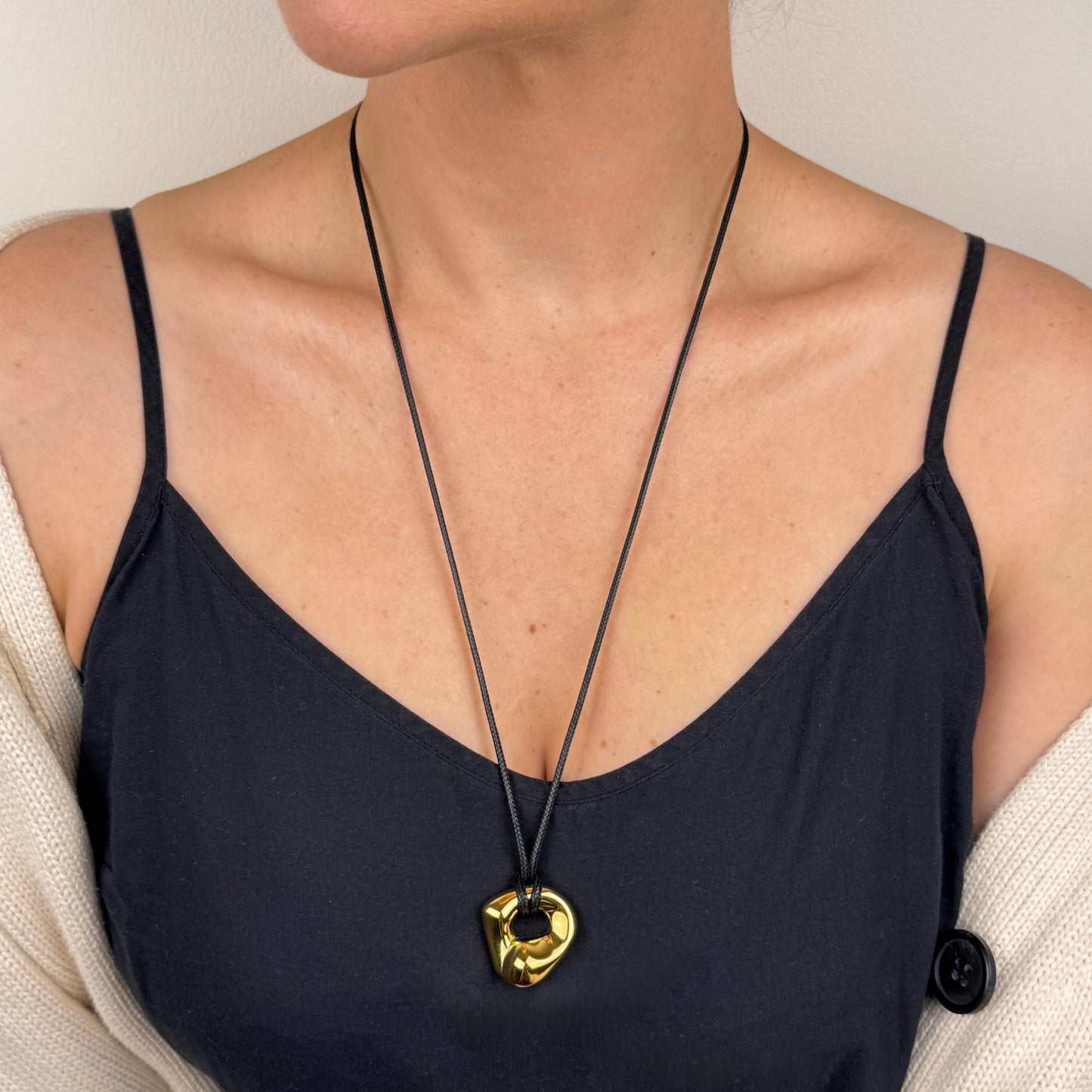 Adjustable gold plated molten irregular nugget pendant on black cord