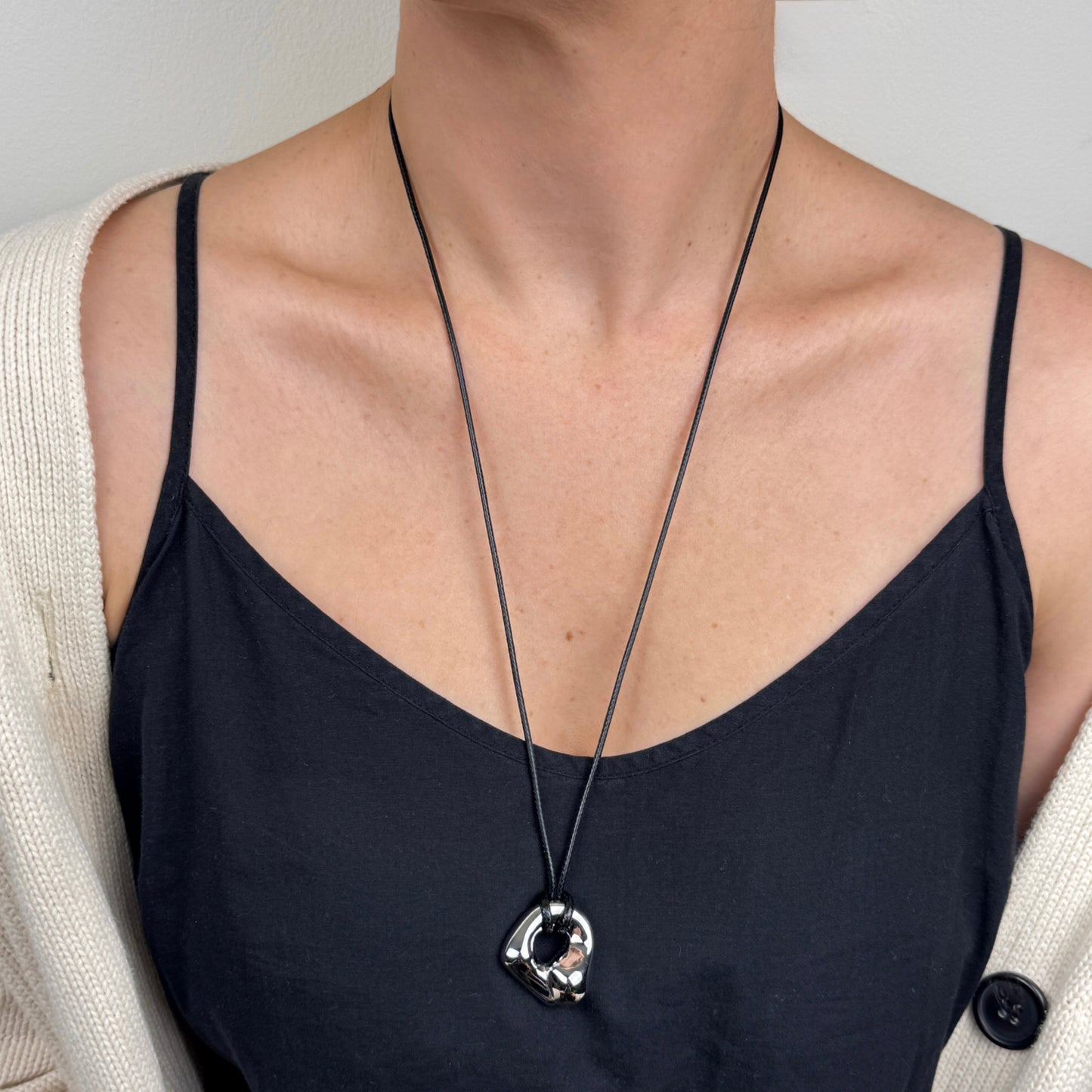 Silver Adjustable molten irregular nugget pendant on black cord