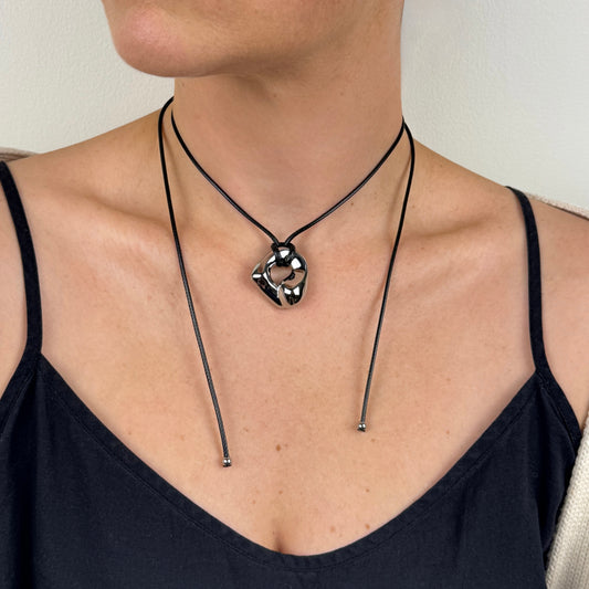 Silver adjustable molten irregular nugget pendant on black cord